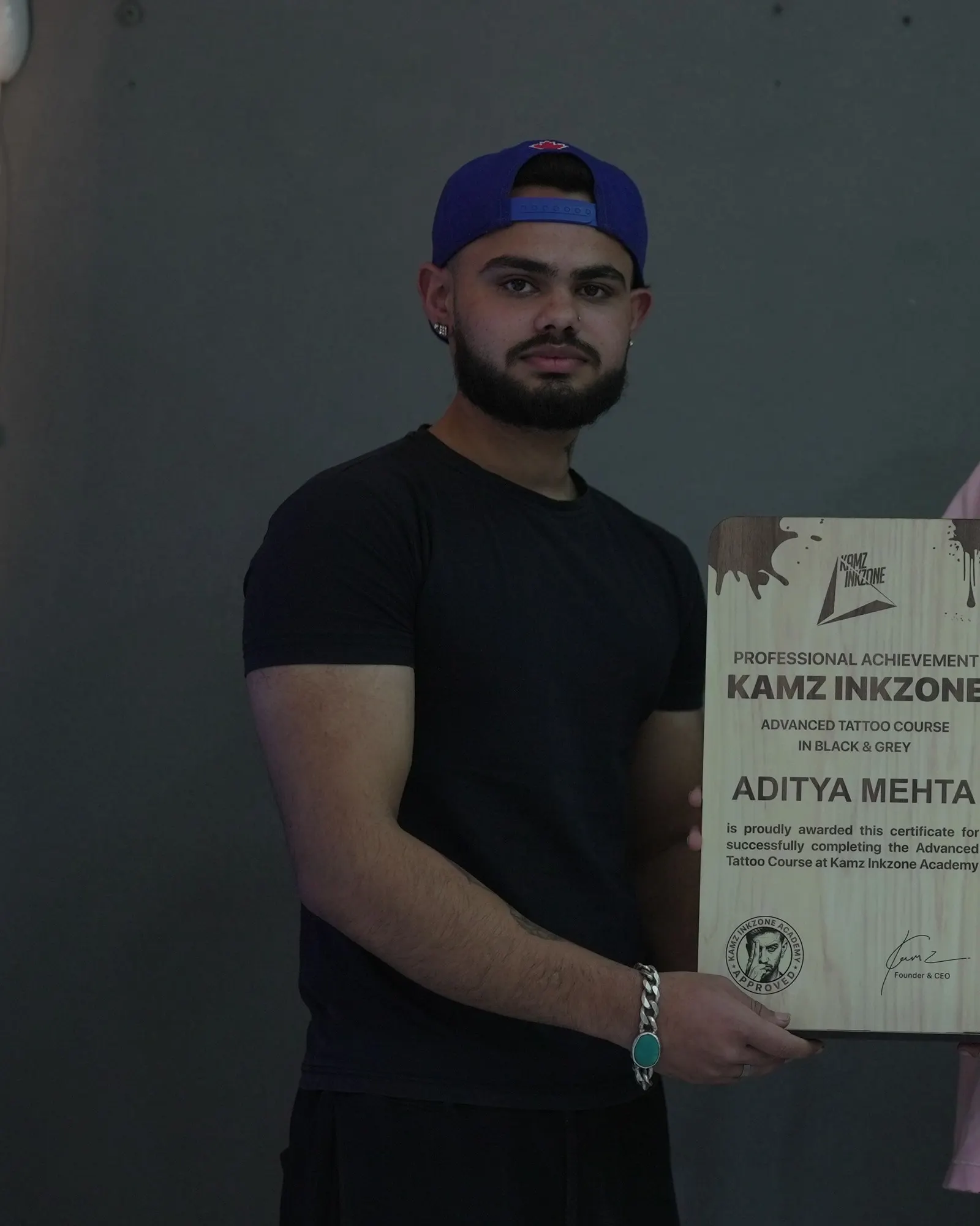 Aditya Mehta, holding the Kamz Inkzone Academy Advanced Tattoo Course certificate