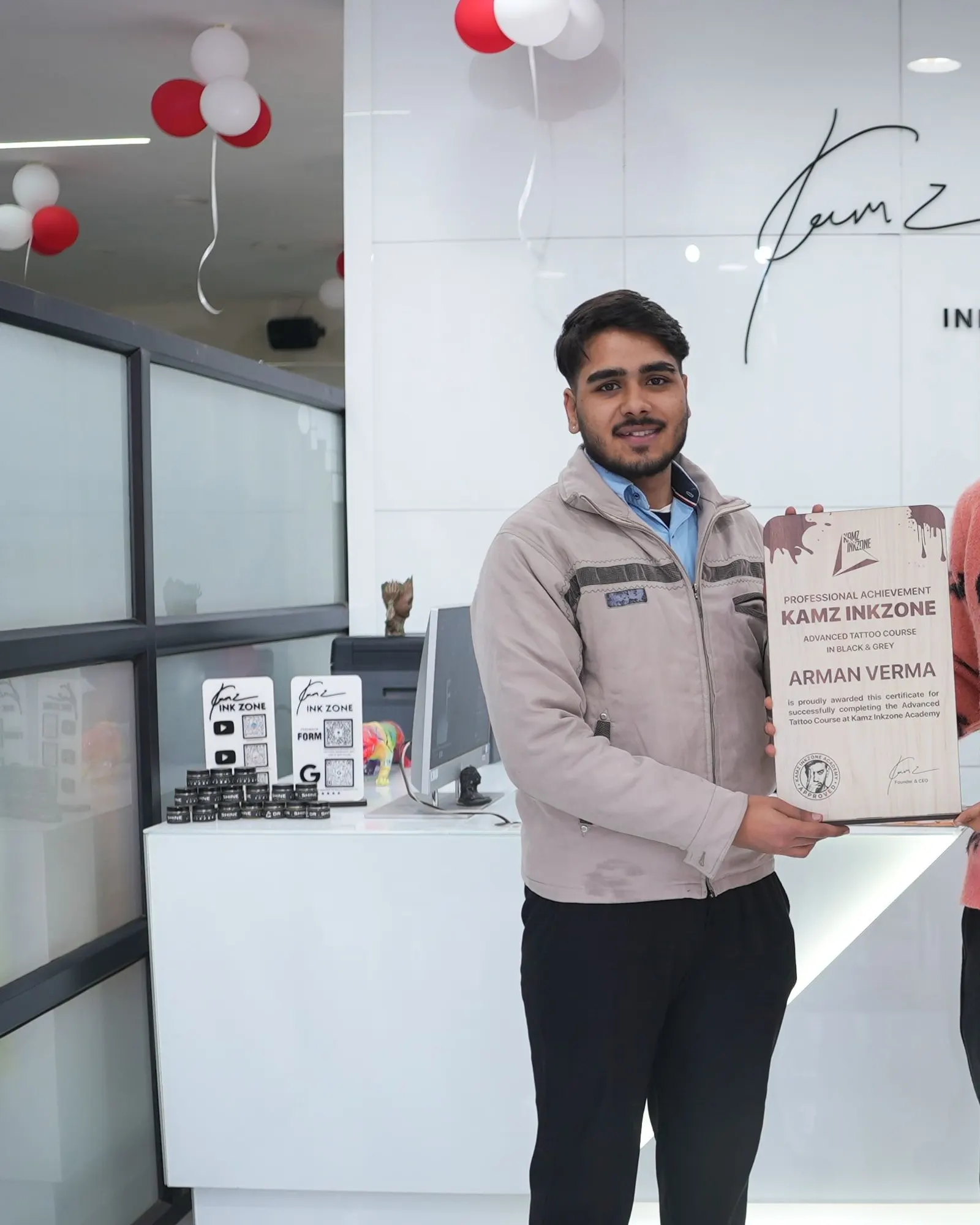 Arman Verma, holding the Kamz Inkzone Academy Advanced Tattoo Course certificate