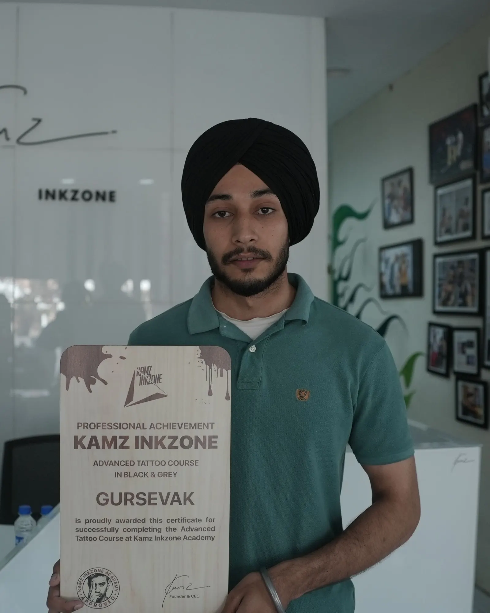 Gursevak, holding the Kamz Inkzone Academy Advanced Tattoo Course certificate