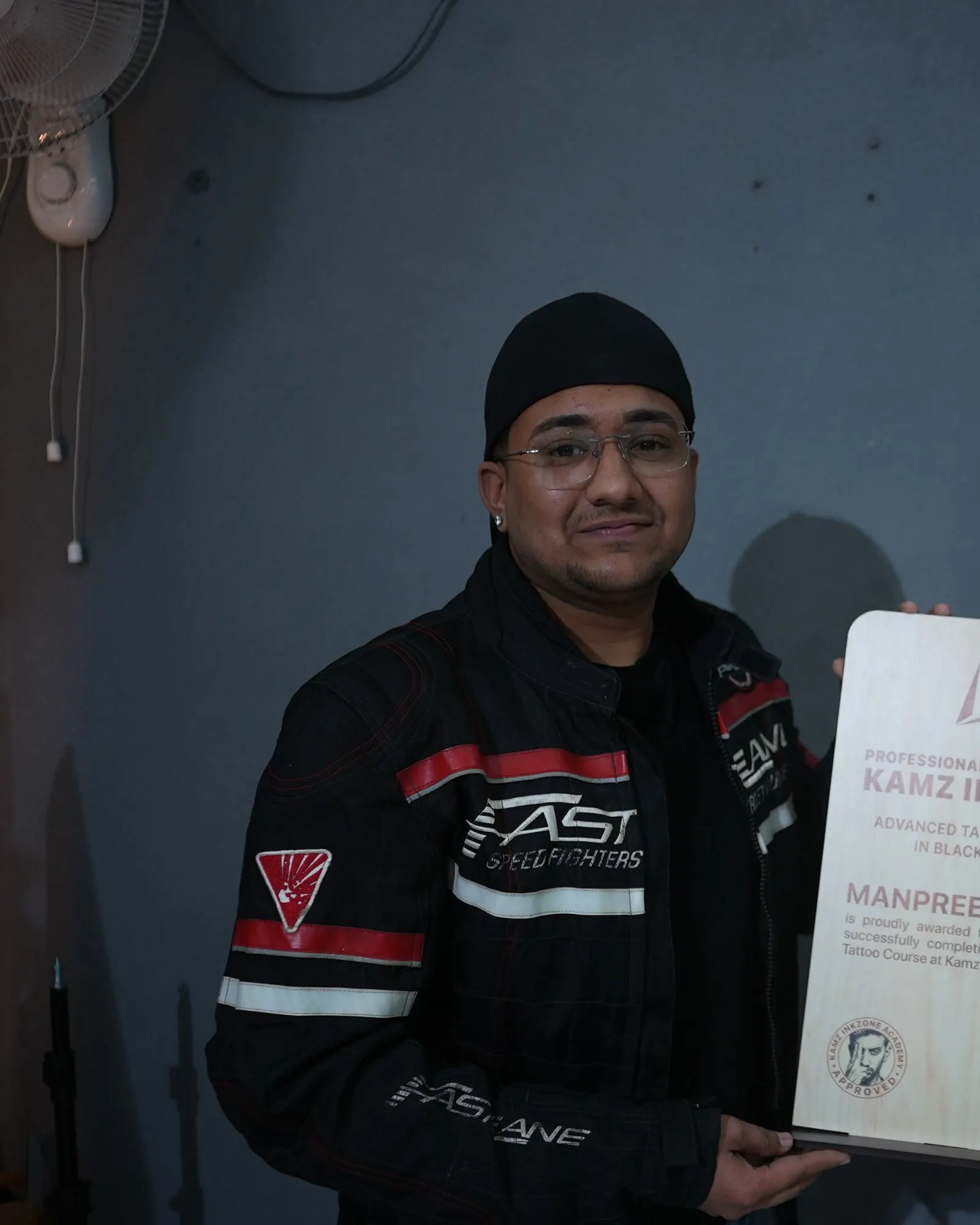 Manpreet Singh, holding the Kamz Inkzone Academy Advanced Tattoo Course certificate