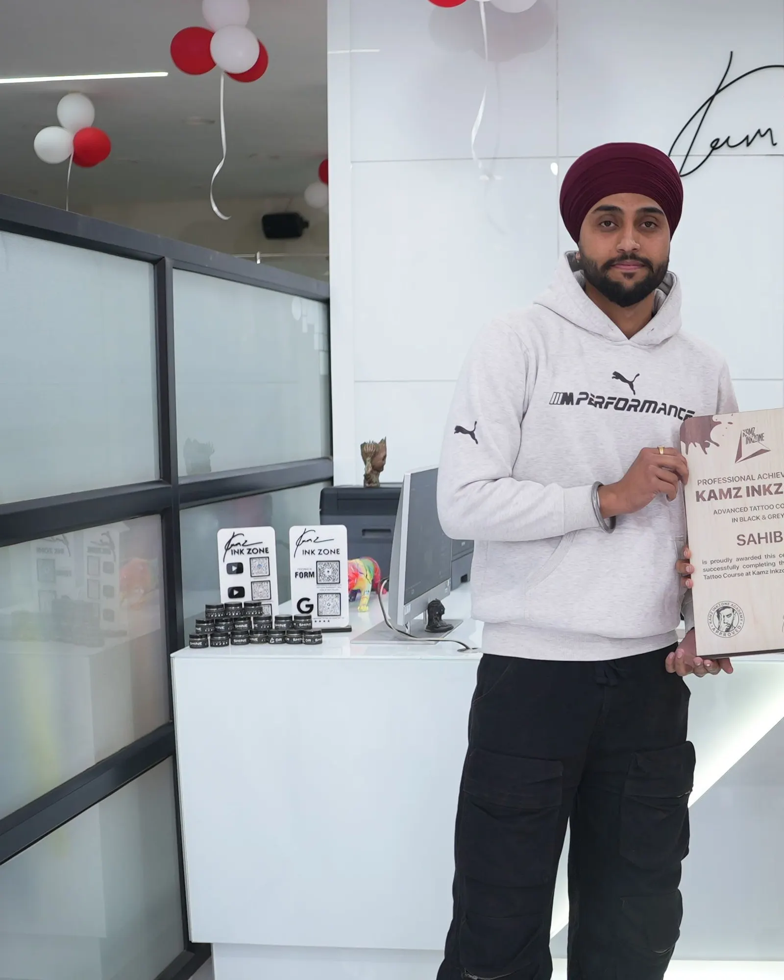 Sahib, holding the Kamz Inkzone Academy Advanced Tattoo Course certificate